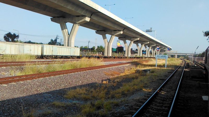 A view of an overpass from a train station parallel to it