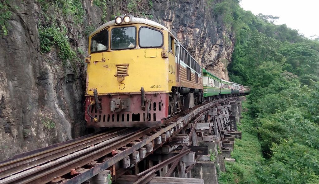 Train on the Wampo Viaduct, running alongside a cliff