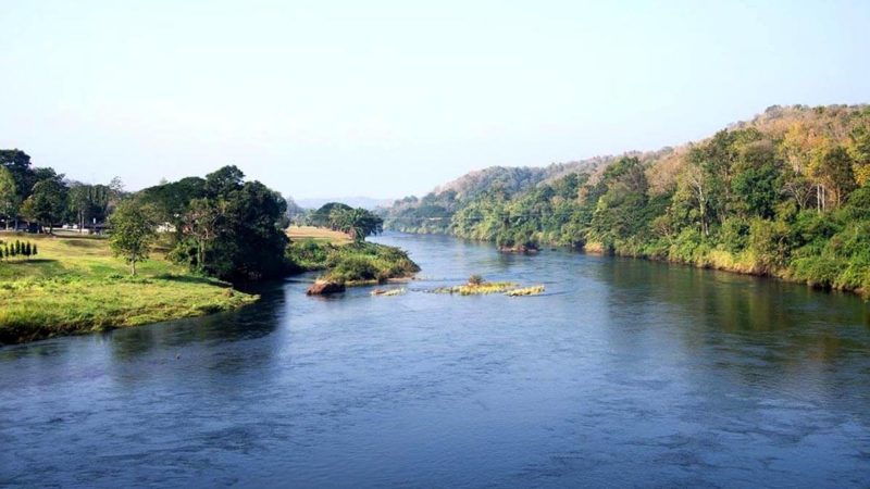 A wide river with green banks